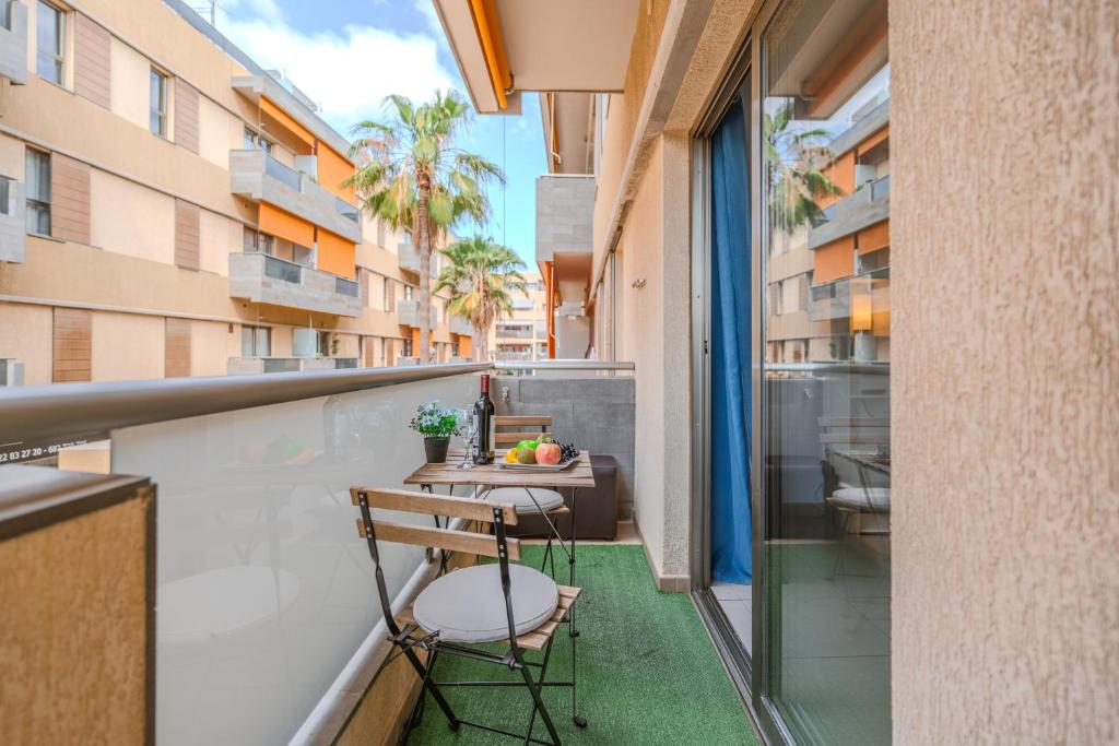 a balcony with a table and chairs on a building at Casa More Alcalá Center in Alcalá