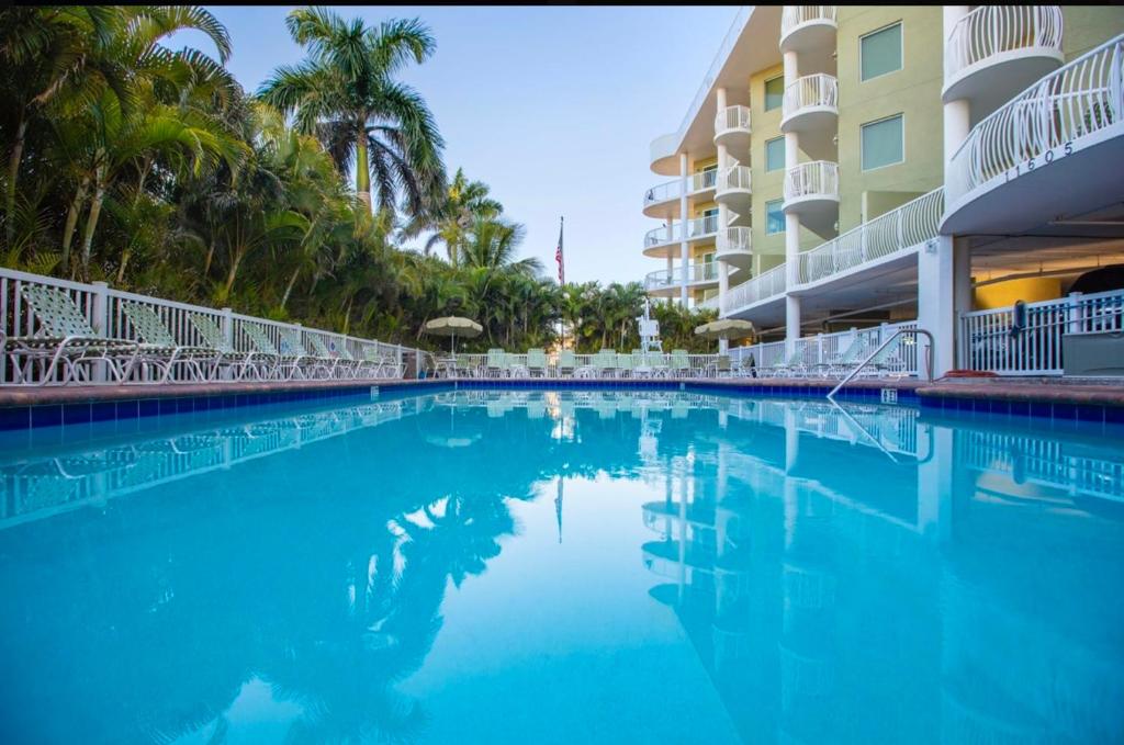 a swimming pool in front of a hotel at Crystal Palms Resort Treasure Island Penthouse Unit 603 in St Pete Beach