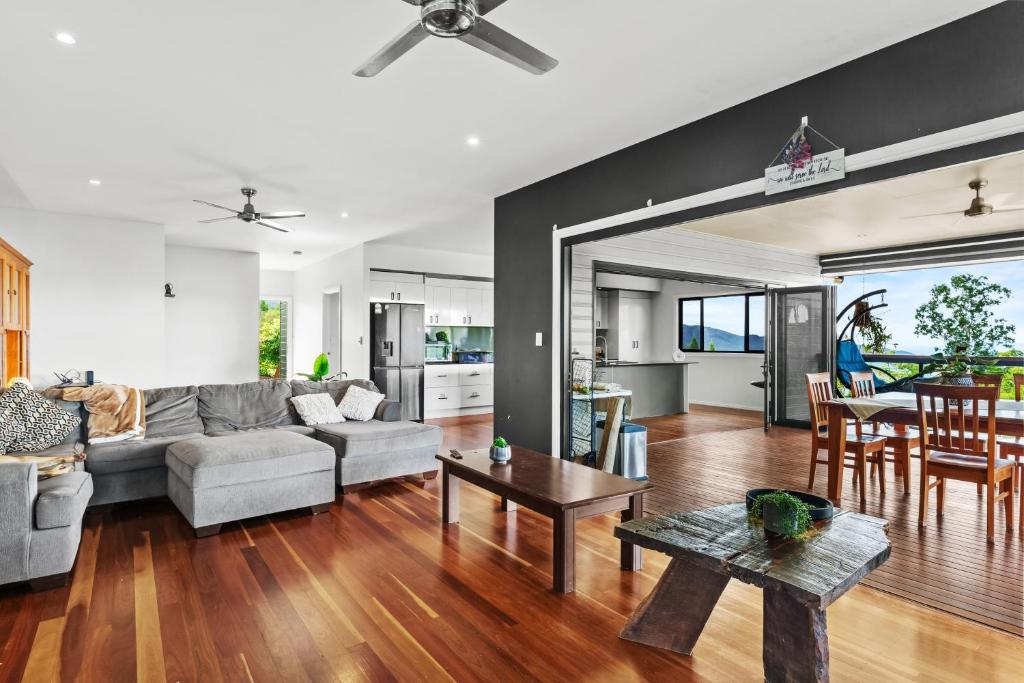 a living room with a couch and a table at Atherton Tablelands -great views & pet friendly in Tolga