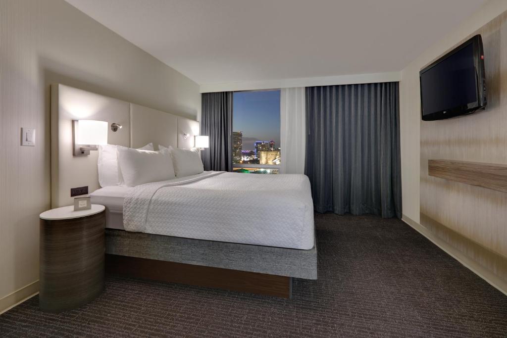 a hotel room with a bed and a large window at Crowne Plaza Hotel Dallas Downtown, an IHG Hotel in Dallas