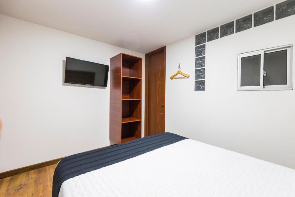 Postel nebo postele na pokoji v ubytování Hotel Casa Botero 204