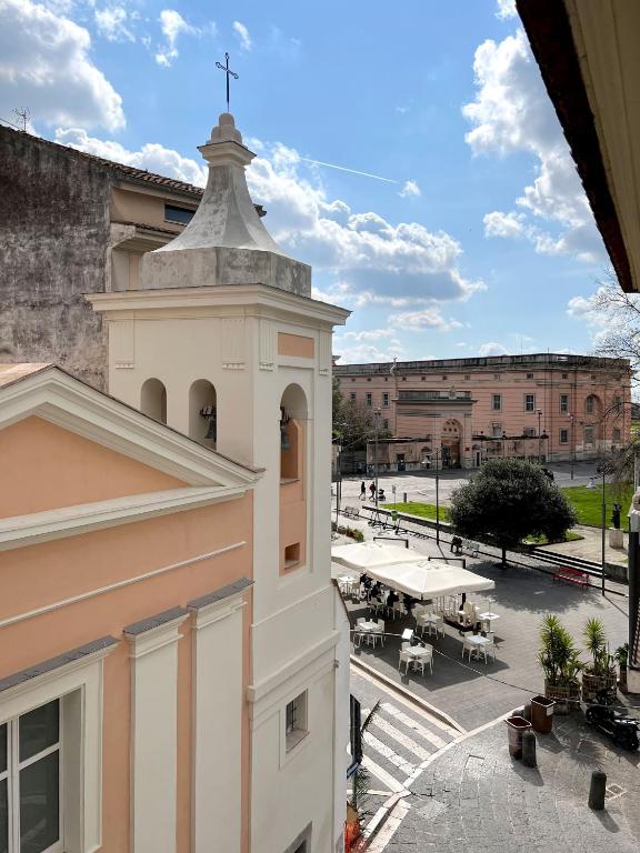 a white building with a cross on top of it at Le Muse Loft in Caserta