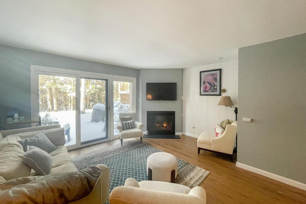 a living room with a couch and a fireplace at Waterville Vacation Condo in Waterville Valley