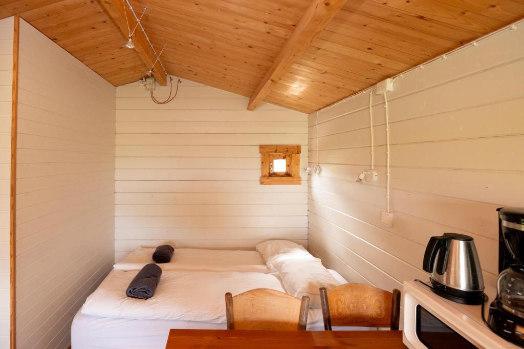 Postel nebo postele na pokoji v ubytování Gladheimar Cottages