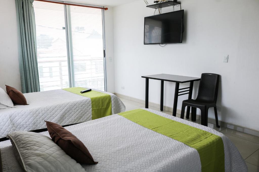 Postel nebo postele na pokoji v ubytování Hotel Casa Botero 303