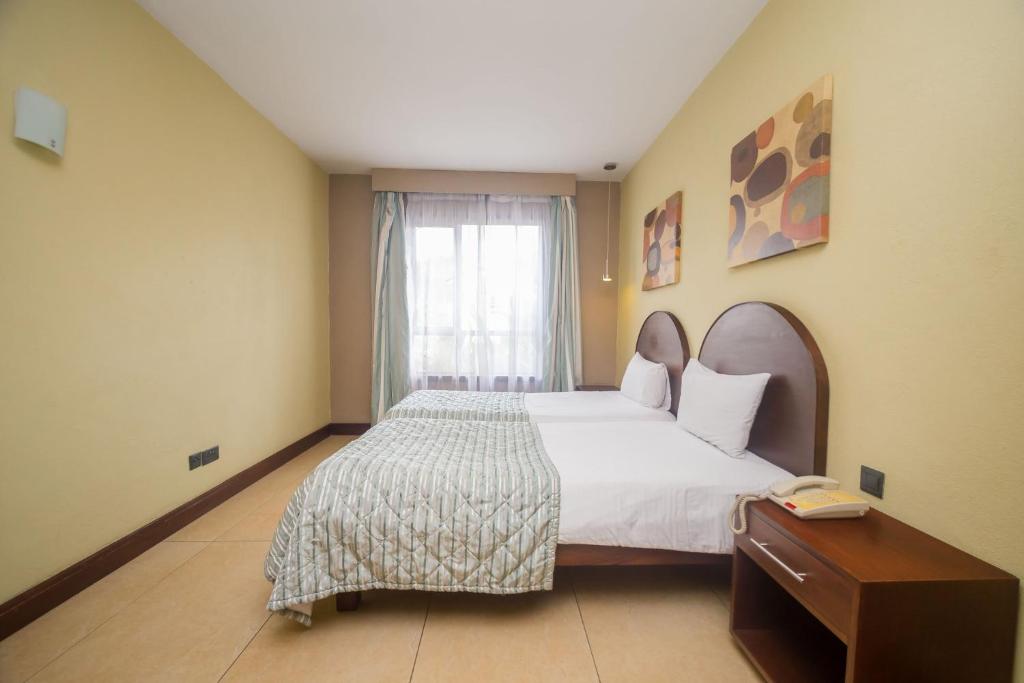 Postel nebo postele na pokoji v ubytování Taarifa Suites by Dunhill Serviced Apartments