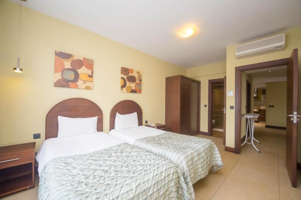 Postel nebo postele na pokoji v ubytování Taarifa Suites by Dunhill Serviced Apartments