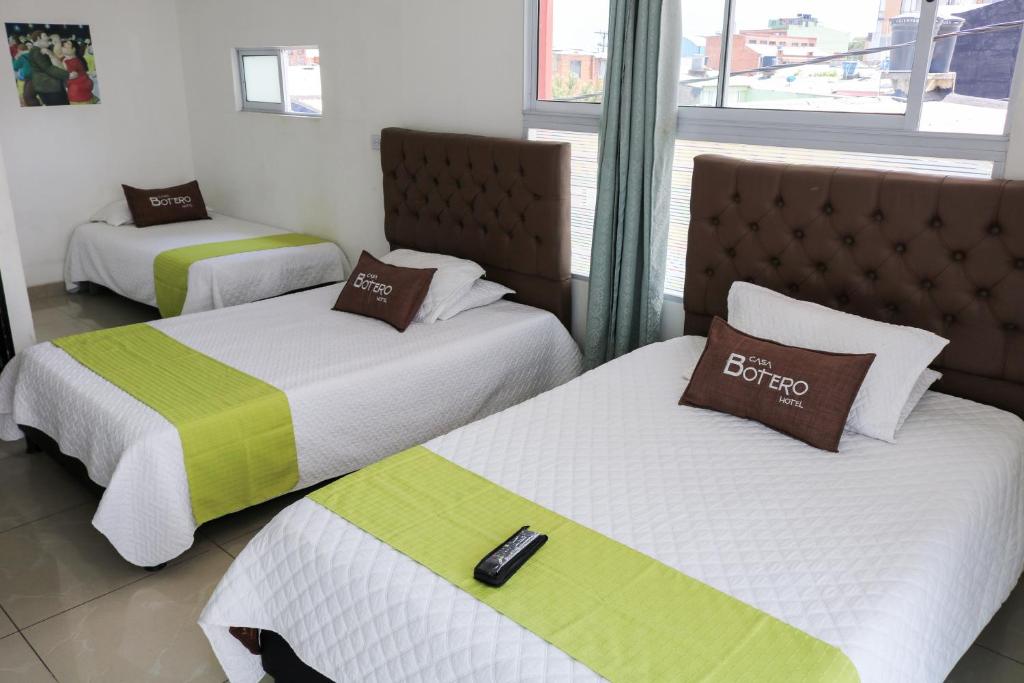 Postel nebo postele na pokoji v ubytování Hotel Casa Botero 303