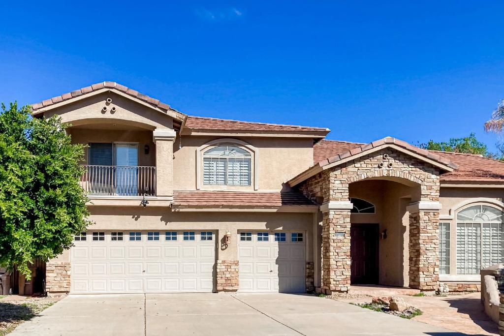 a large brick house with a garage at Desert Dreamland Villa in Peoria