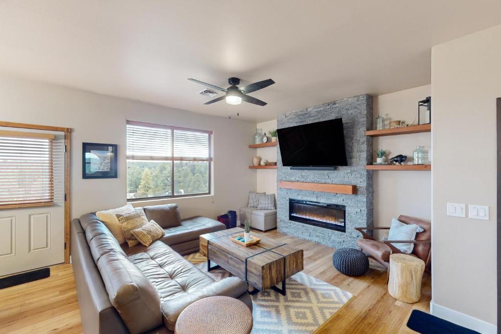 a living room with a couch and a fireplace at Ridgetop Retreat - Unit A9 in Show Low
