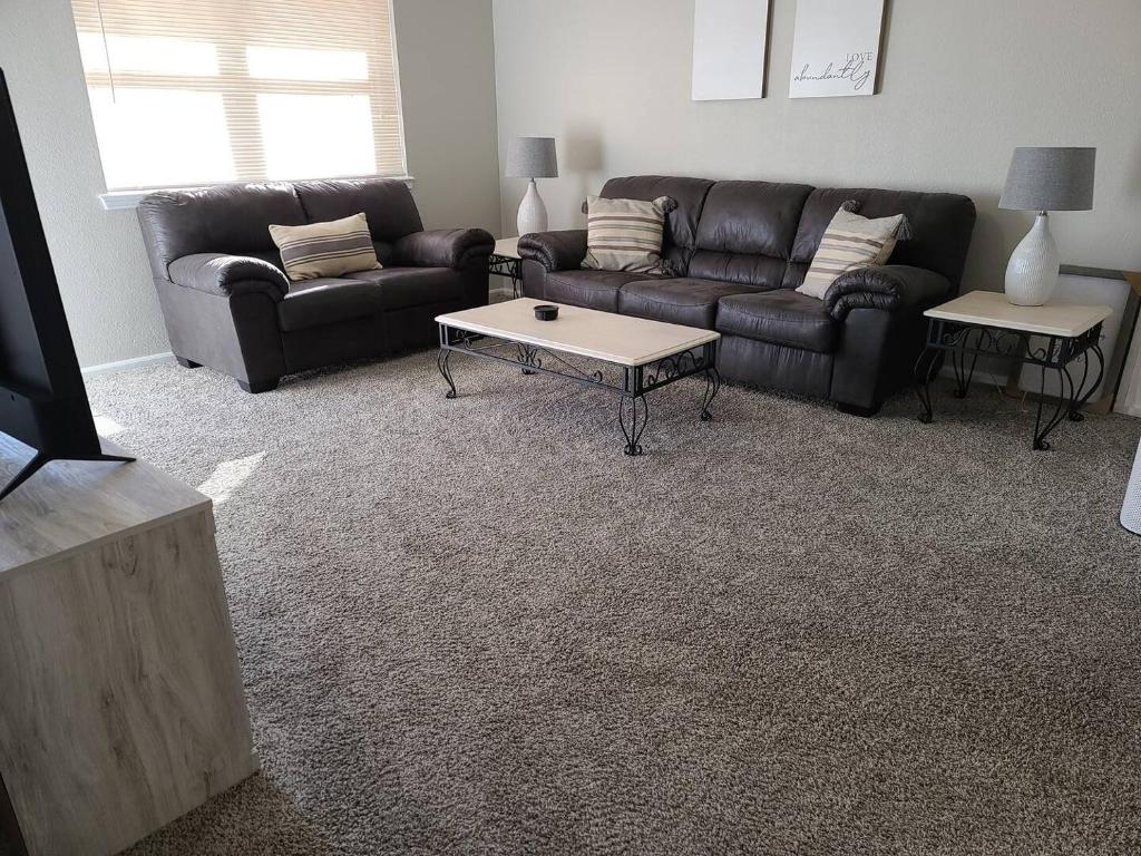 a living room with a couch and a coffee table at The Oasis - C in Clovis
