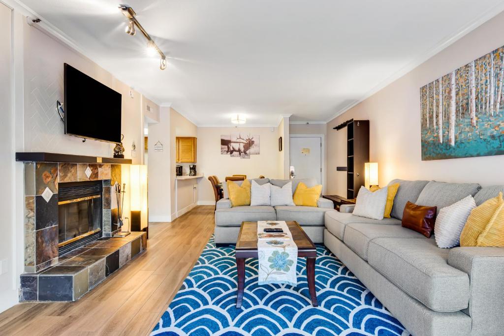a living room with a couch and a fireplace at Park Station #212 in Park City