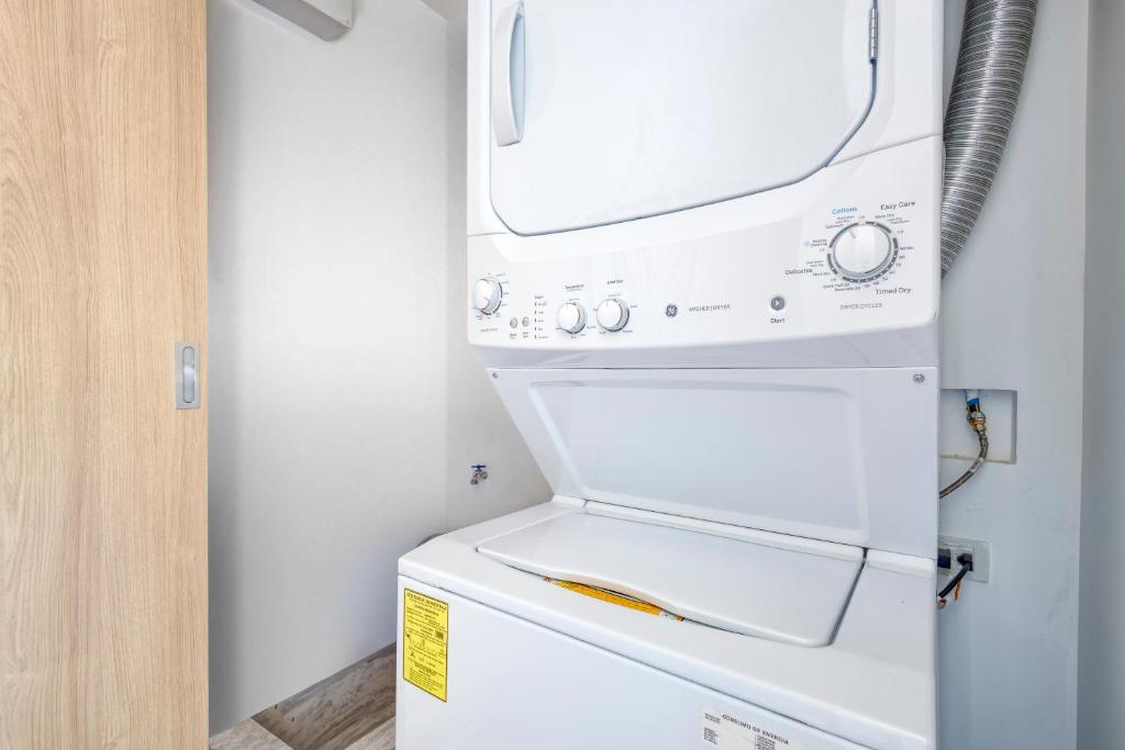 a white washer and dryer in a kitchen at Lumina at Cardinal San José del Cabo in San José del Cabo