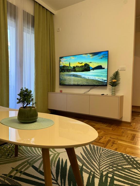 a living room with a flat screen tv on a wall at RS lux Becici in Becici