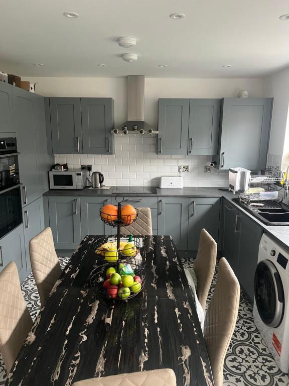 a kitchen with a table with a bowl of fruit on it at 119 in Wrockwardine