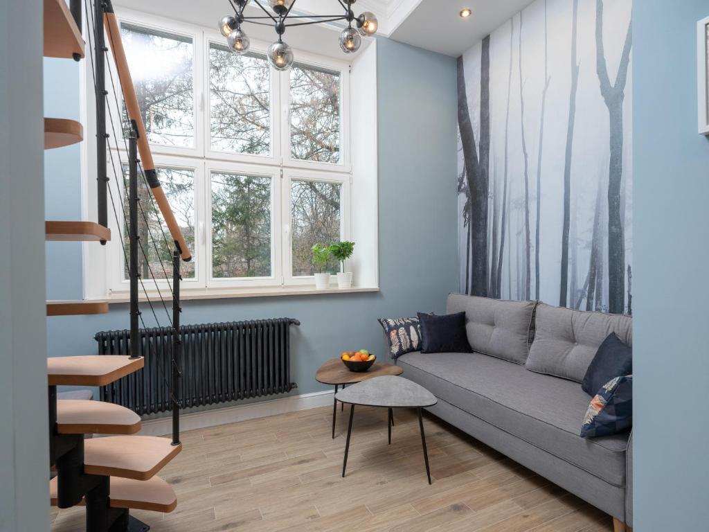 a living room with a couch and a window at Erasmus Student Apartments - Old Town in Kraków