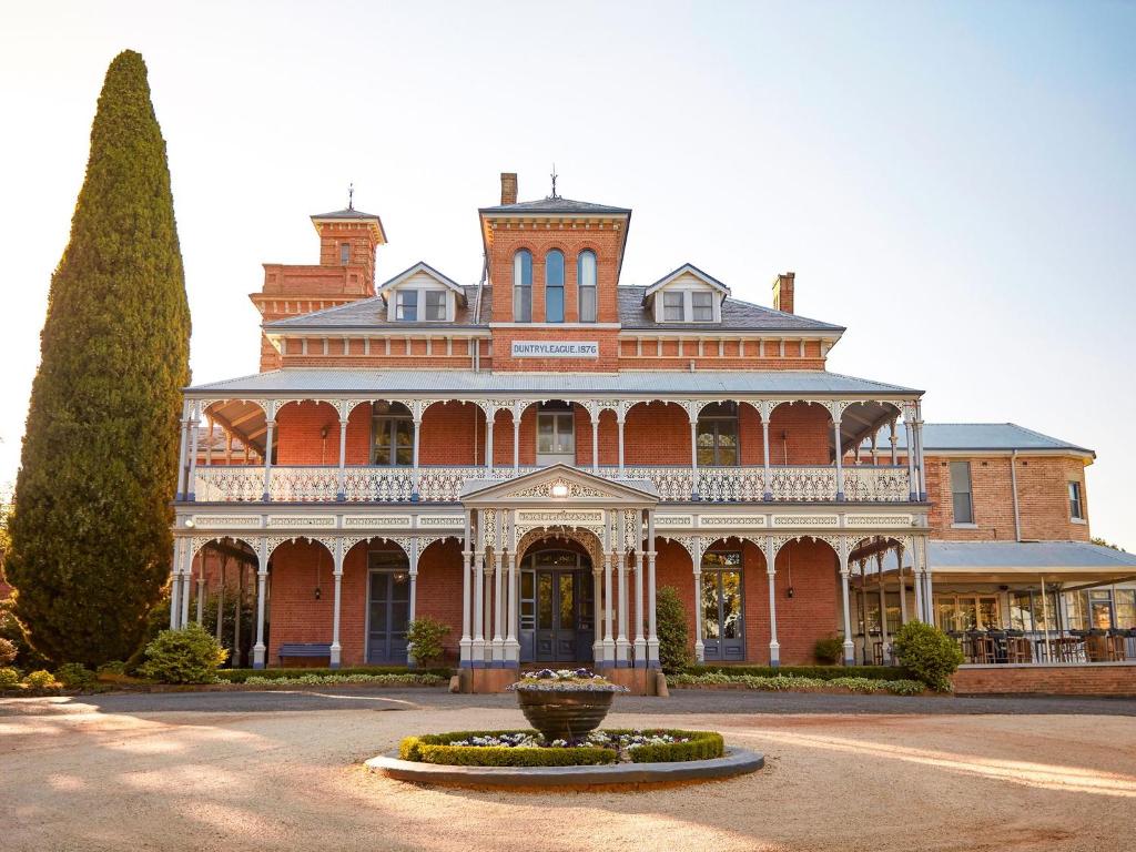 a large red brick building with a vase in front of it at Duntryleague in Orange