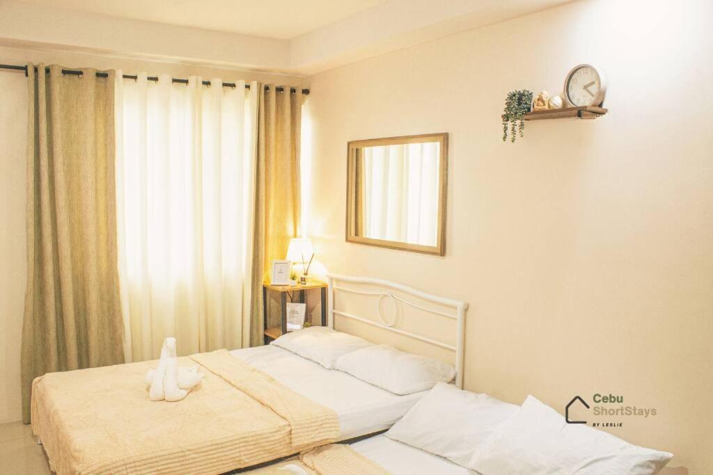 um quarto com 2 camas e uma janela em Cozy Studio Unit at Persimmon em Cebu