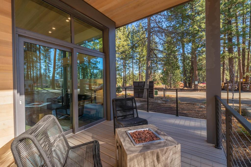 a screened in porch with a table and chairs at Village Camp in Truckee
