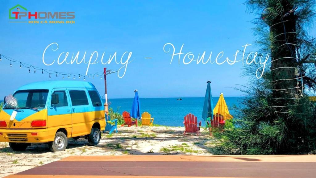 a van parked on a beach with chairs and umbrellas at TP-HOMES PHAN THIẾT in Phan Thiet