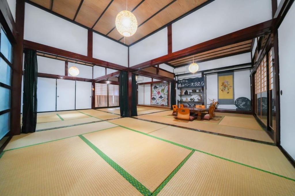 a living room with a large room with a large window at 貸切民泊勝山ベース325 福井県立恐竜博物館まで車で5分 