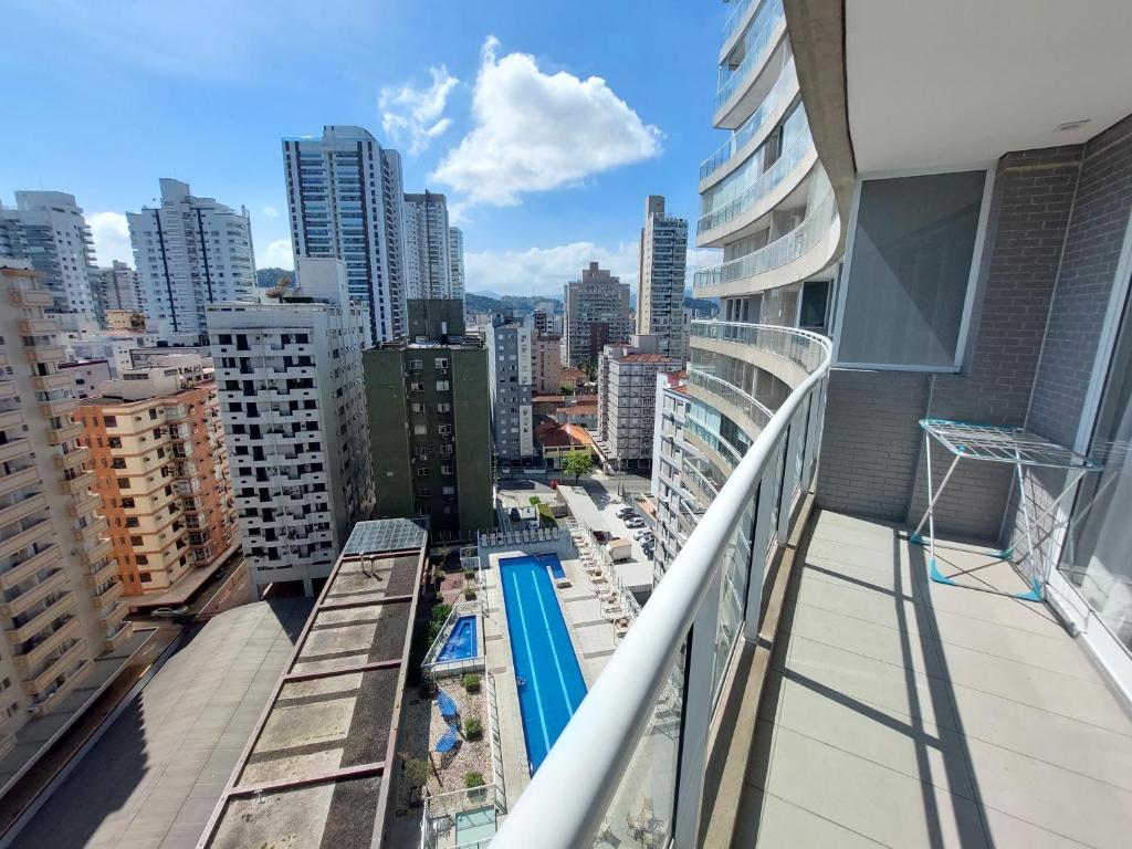 a balcony with a swimming pool on a building at Book Santos - Unlimited 1112 - Um Pé na areia in Santos