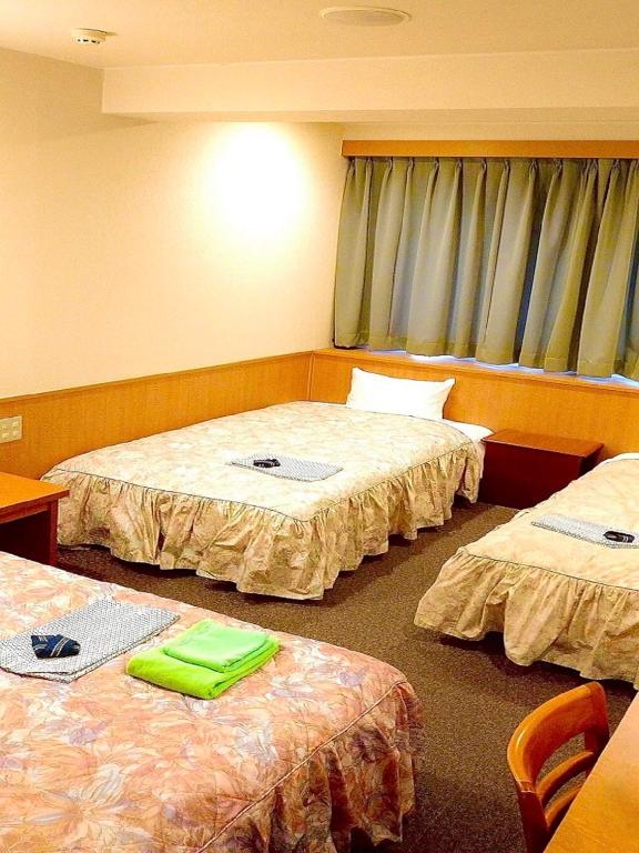 Postel nebo postele na pokoji v ubytování Yonago Universal Hotel