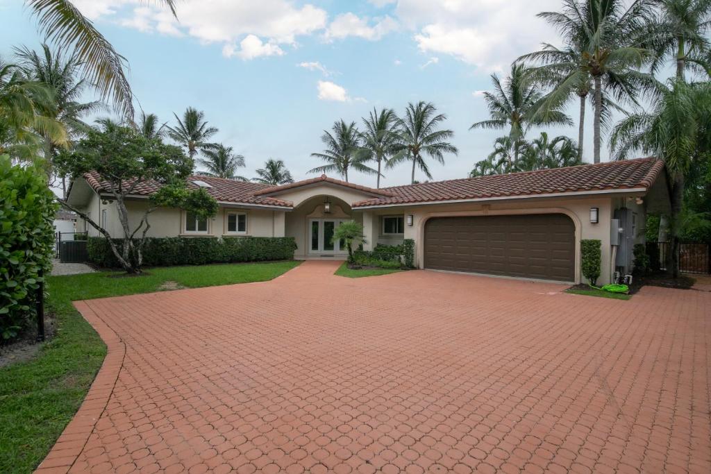 a brick driveway in front of a house at Paradise Manor in Pompano Beach