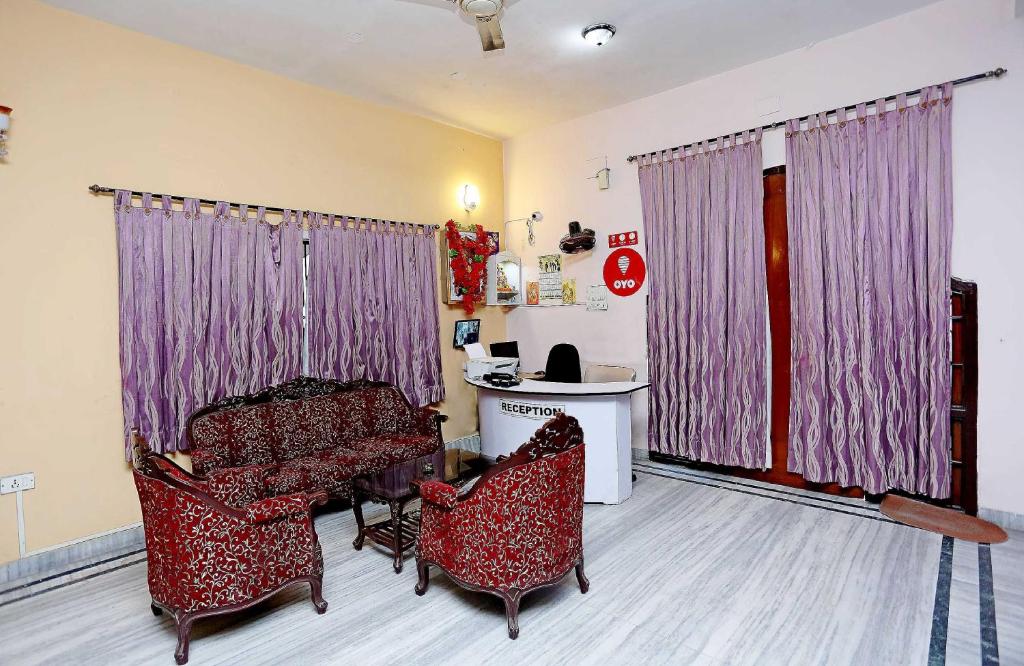 - un salon avec deux chaises, une table et un bureau dans l'établissement Honey Regency Near City Centre Salt Lake, à Kolkata