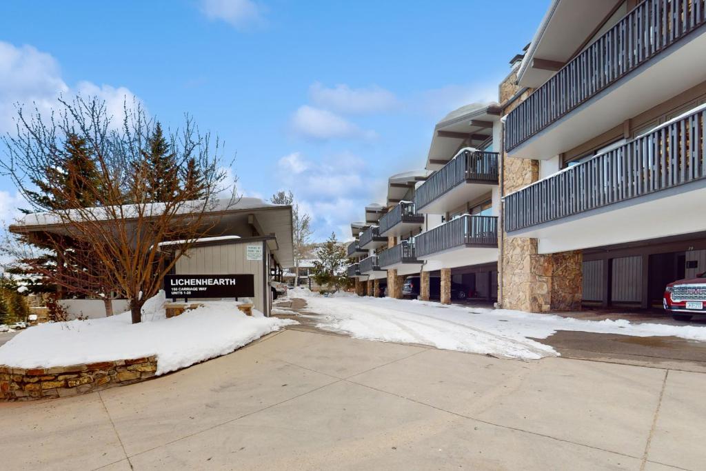 a snow covered street in front of apartment buildings at Lichenhearth # 4 in Snowmass Village