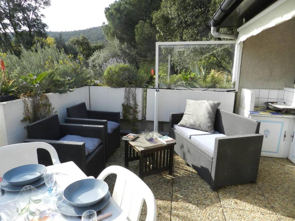 eine Terrasse mit Sofas, einem Tisch und Stühlen in der Unterkunft Appartement Le Lavandou, 2 pièces, 4 personnes - FR-1-251-769 in Le Lavandou