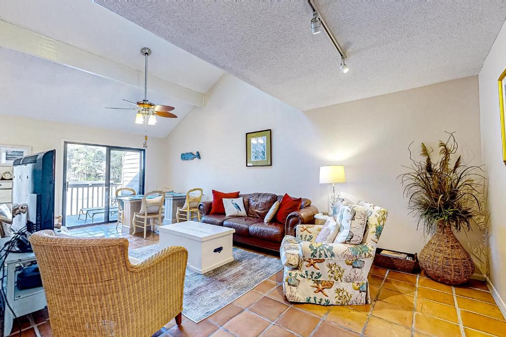 a living room with a couch and chairs at Nature Retreat in Seabrook Island