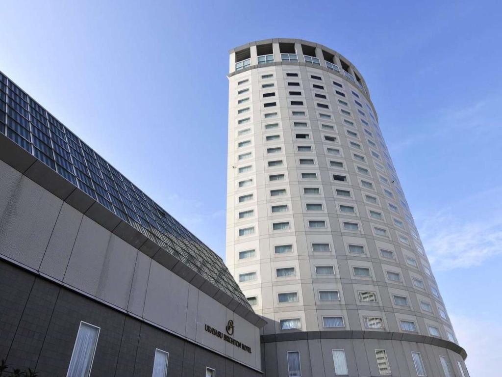 a tall white building next to a building at Urayasu Brighton Hotel Tokyo Bay in Urayasu