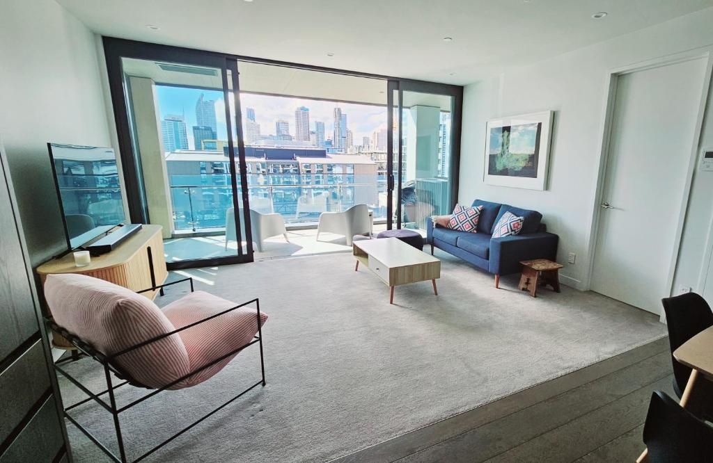 a living room with a view of a city at Wynyard Quarter One Bedroom Apartment in Auckland