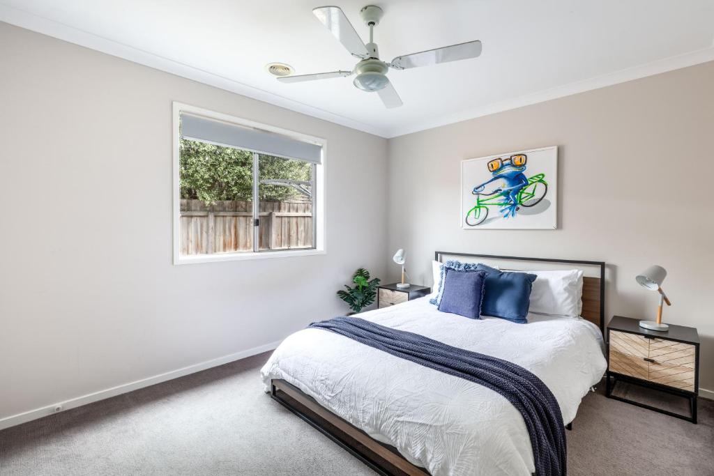 a bedroom with a bed with a bike on the wall at Oakdean Resort- Pool, Spa, Beach, Sleep 10 in Ocean Grove