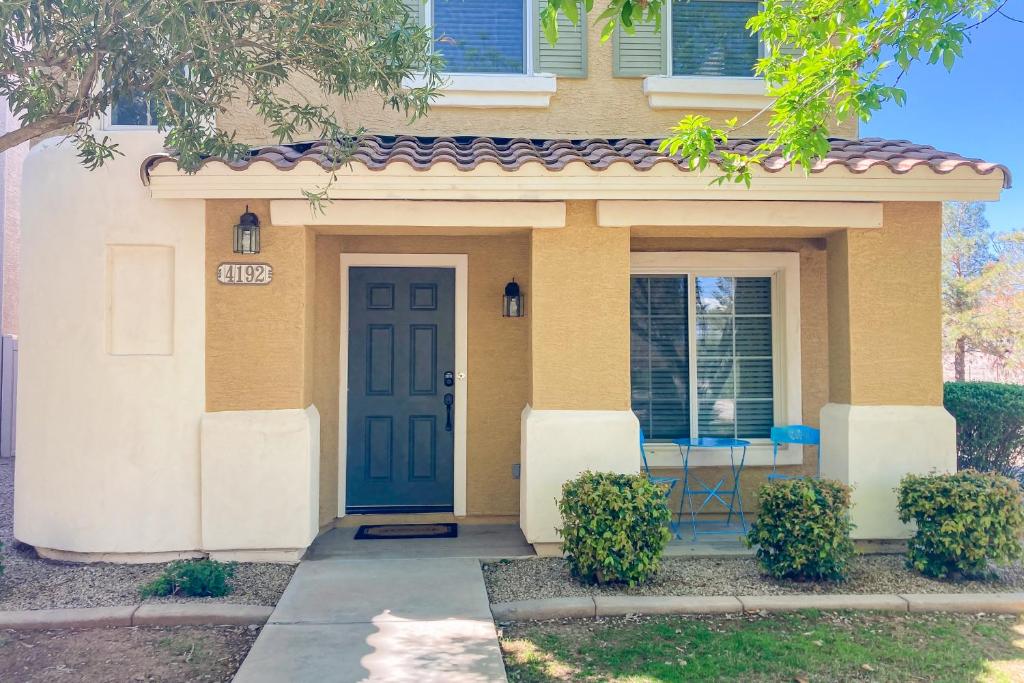 ein Haus mit einer blauen Tür davor in der Unterkunft Garden Breeze in Gilbert