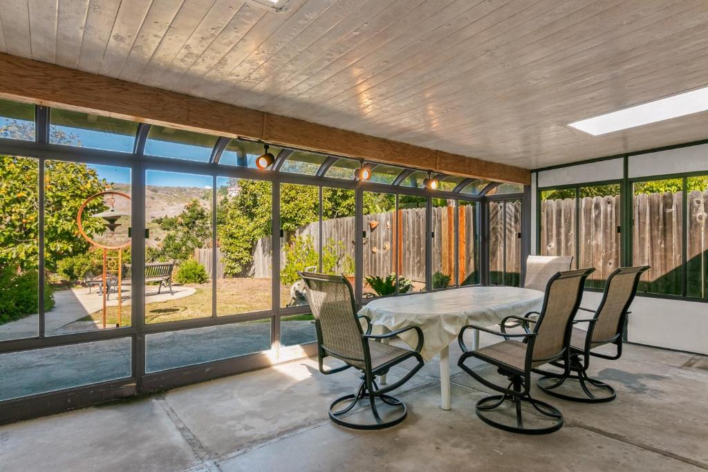 a screened in porch with a table and chairs at Colorful Gold Coast Getaway in Santa Barbara