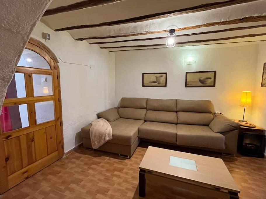 a living room with a couch and a table at Casa rural in Puebla de Don Fadrique