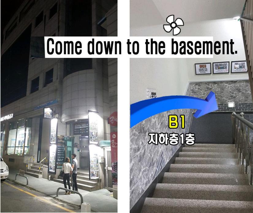 a picture of a staircase with a sign that says come down to the basement at Capsule24 in Incheon