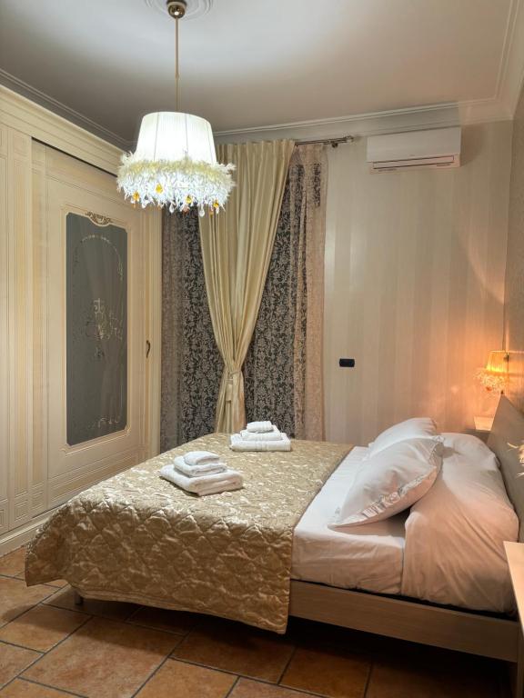 a bedroom with a bed with two towels on it at MG Luxury Home in Naples