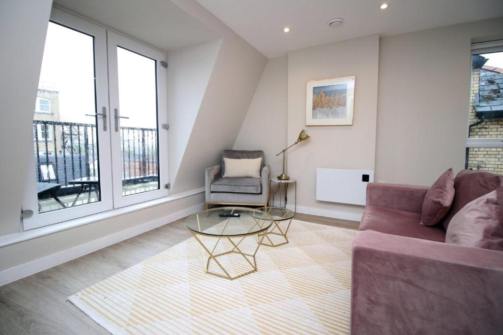 a living room with a couch and a glass table at Casablanca 18 - Cardiff Bay - 2 Bed Apartment in Cardiff