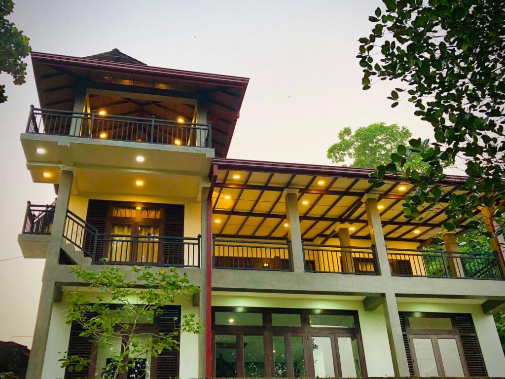 a large building with a balcony on top of it at The villa on the Rock in Talpe