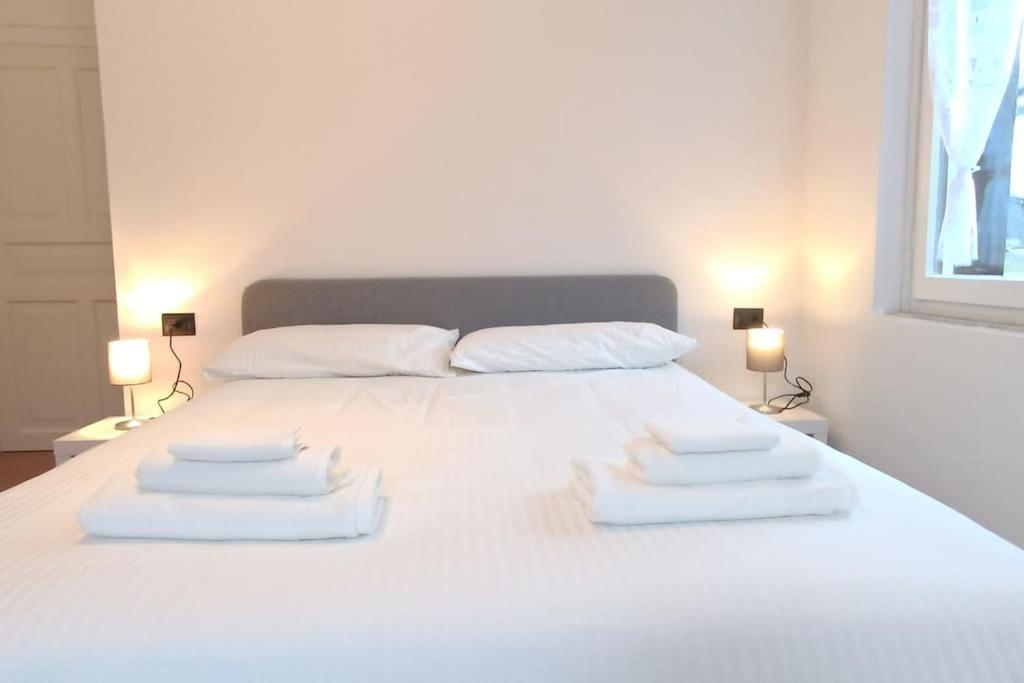 un letto bianco con tre cuscini sopra di Vicino Zoncolan+Netflix e Wifi a Treppo Carnico