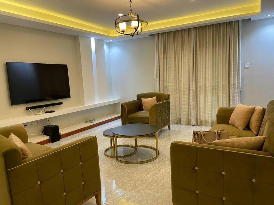 a living room with two couches and a tv at City View No 5, Mawanda Road. in Kampala