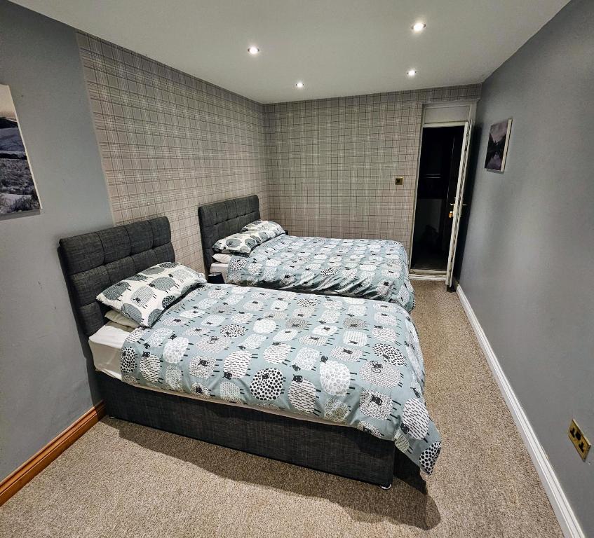 a bedroom with two beds in a room at The Pit Stop Cafe and Accomodation in Cymmer