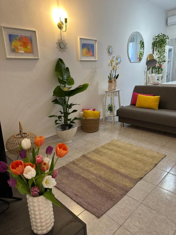 ein Wohnzimmer mit einer Blumenvase auf dem Tisch in der Unterkunft Appartamento Mirsie in Bologna