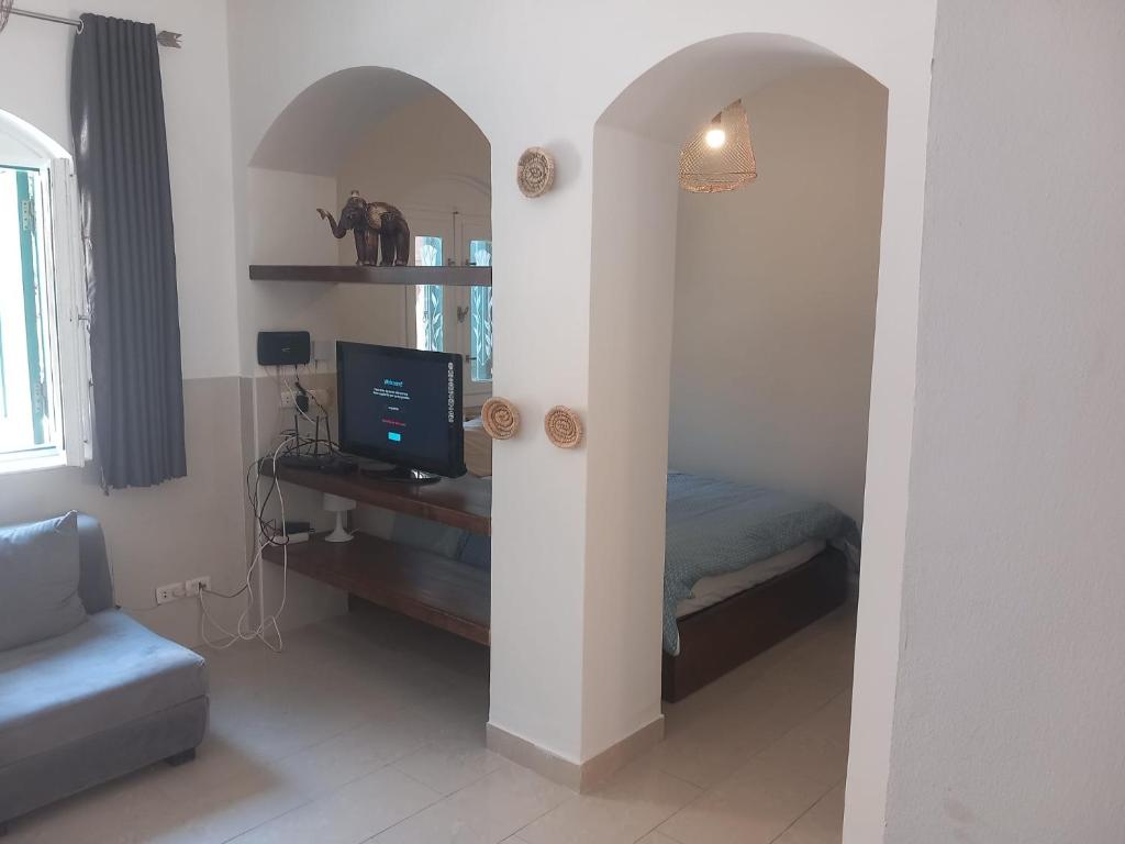 a bedroom with a bed and a tv in a room at Studio in the heart of El Gouna in Hurghada