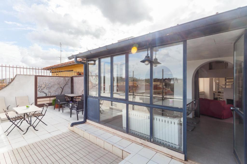 a balcony with glass doors and a table and chairs at Prati Belfiore Guesthouse in Rome