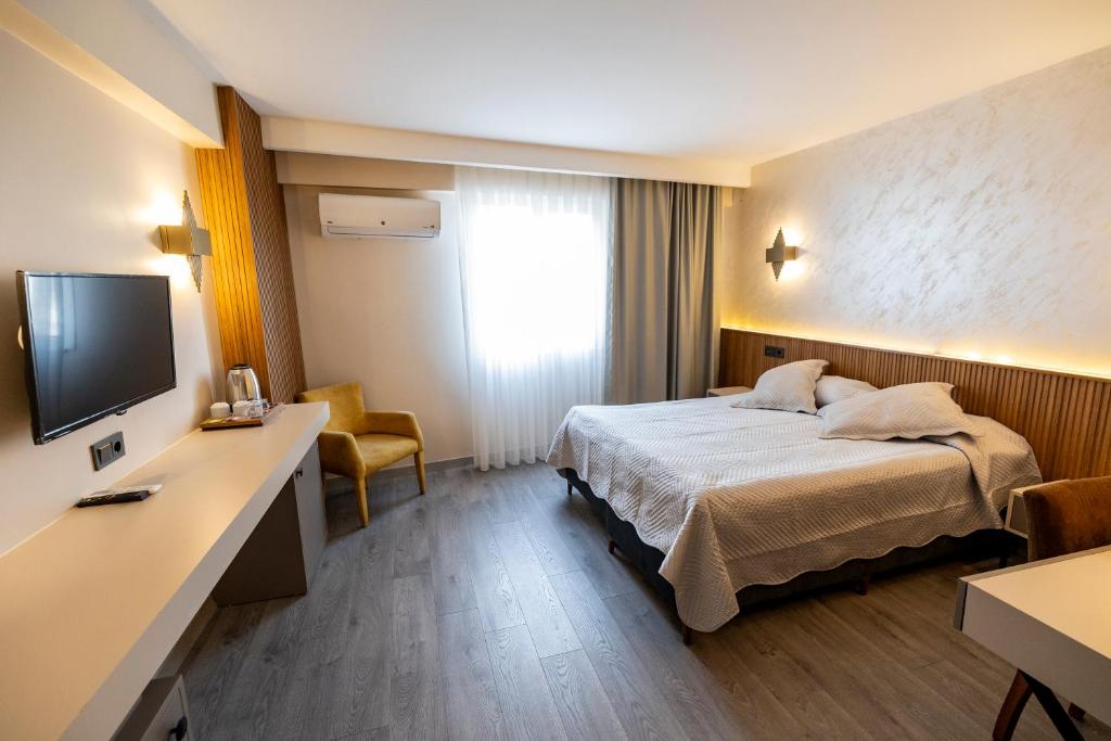 Postel nebo postele na pokoji v ubytování Aktas Hotel