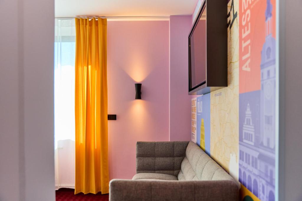 TV a/nebo společenská místnost v ubytování McDreams Hotel Leipzig